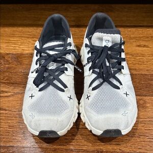 On Running White and Black Athletic Shoes